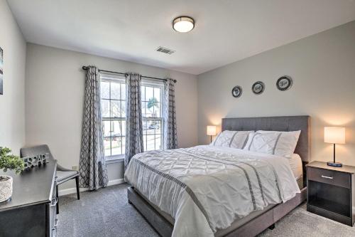 a bedroom with a bed and a desk and a window at Deck and Yard Family-Friendly Lawrenceville Home! in Lawrenceville