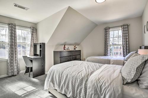 a bedroom with two beds and a desk at Deck and Yard Family-Friendly Lawrenceville Home! in Lawrenceville