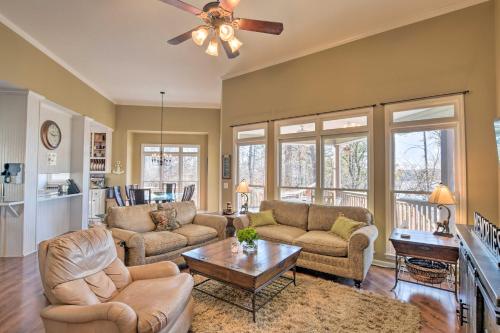 a living room with two couches and a table at Lavonia Lake House with Private Dock and Bonfire! in Lavonia