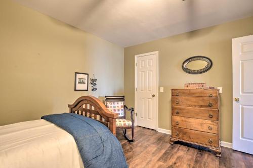 a bedroom with a bed and a wooden dresser at Lavonia Lake House with Private Dock and Bonfire! in Lavonia