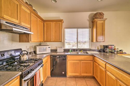 a kitchen with wooden cabinets and a stove top oven at Borrego Springs Stargazing Home with Mtn Views in Borrego Springs