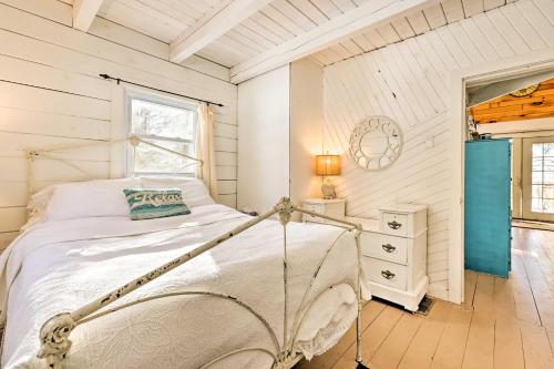 a white bedroom with a bed and a window at Private Lake Access and Canoes Pennsylvania Cottage in Lakewood