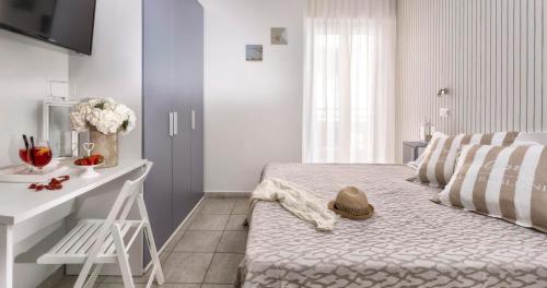 a bedroom with a bed with a hat on it at Hotel Clitunno in Misano Adriatico