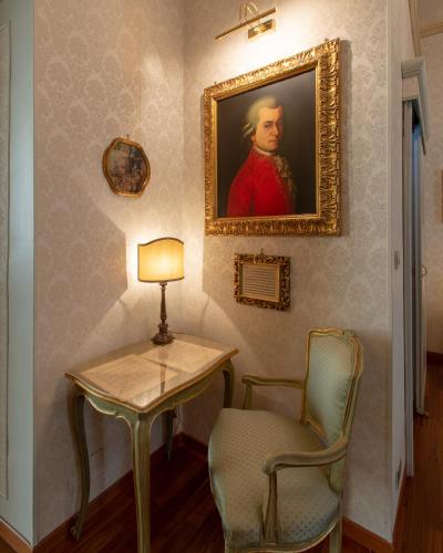 a table and a chair and a painting on a wall at Hotel Antica Dogana in Turin