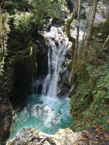 a waterfall in the middle of a river at APARTMA KAAN in Žaga