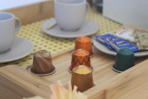 a wooden table withcolored candles on a table with cups at La Chimère Buzios Essence in Búzios