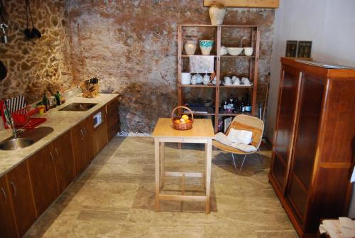 a kitchen with a counter and a table in it at CASA DE DOÑA MARIA VALDELARCO in Valdelarco