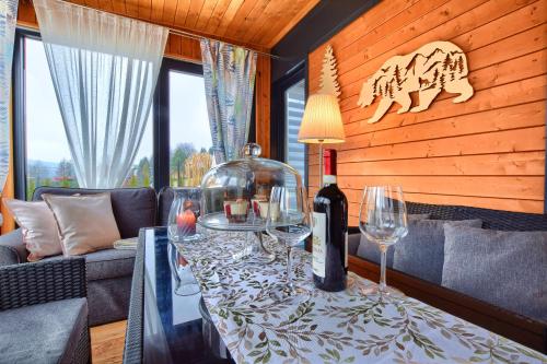 a dining room with a table with wine glasses at Osada Kotarz in Brenna