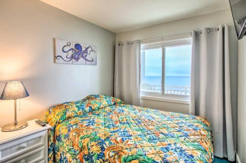 a bedroom with a bed and a window with the ocean at Direct Beach Access North Myrtle Condo! in Myrtle Beach