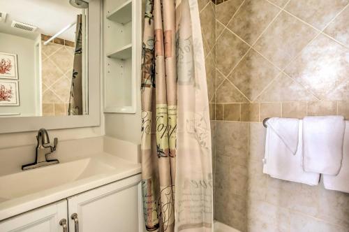 a bathroom with a shower curtain and a sink at Direct Beach Access North Myrtle Condo! in Myrtle Beach