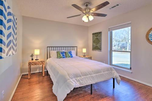 a bedroom with a bed and a ceiling fan at Modern Fayetteville Home Less Than 1 Mi to U of A! in Fayetteville