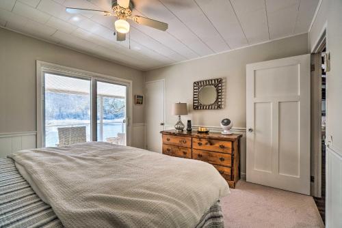 a bedroom with a bed and a dresser and a window at Cozy Lake Santeetlah Cottage with Dock and 3 Kayaks! in Robbinsville