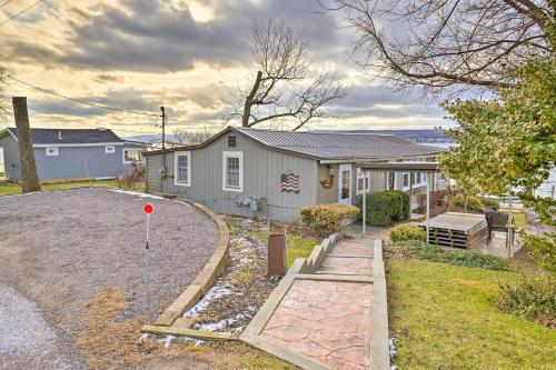a house with a gravel driveway in front of it at Lakefront Canandaigua Home with Grill, Fire Pit in Canandaigua