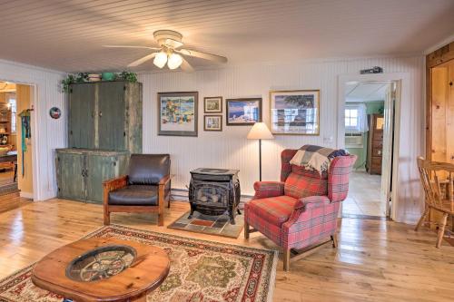 a living room with a couch and chairs and a stove at Lakefront Canandaigua Home with Grill, Fire Pit in Canandaigua