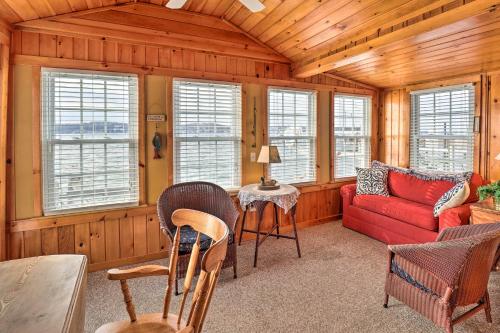 a living room with a red couch and a table at Lakefront Canandaigua Home with Grill, Fire Pit in Canandaigua