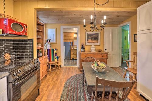 a kitchen with a table and a dining room at Lakefront Canandaigua Home with Grill, Fire Pit in Canandaigua