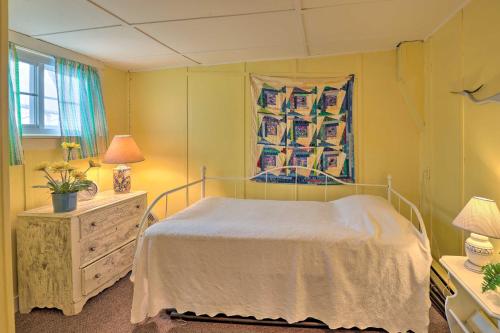 a bedroom with a bed and a painting on the wall at Lakefront Canandaigua Home with Grill, Fire Pit in Canandaigua