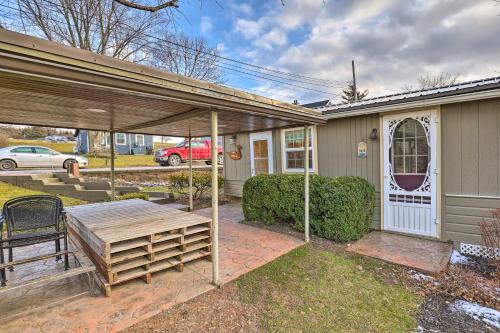 a house with a patio with a table and a bench at Lakefront Canandaigua Home with Grill, Fire Pit in Canandaigua