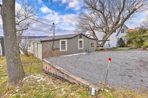 a house with a gravel driveway with a tree at Lakefront Canandaigua Home with Grill, Fire Pit in Canandaigua