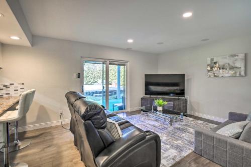 a living room with a couch and a television at Movie Room and Private Pool Richardson Retreat in Richardson