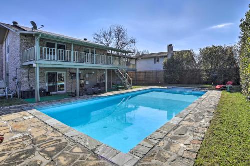 a swimming pool in front of a house at Movie Room and Private Pool Richardson Retreat in Richardson