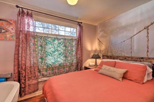 a bedroom with a red bed and a window at The Purple House Apt in Downtown Flagstaff! in Flagstaff