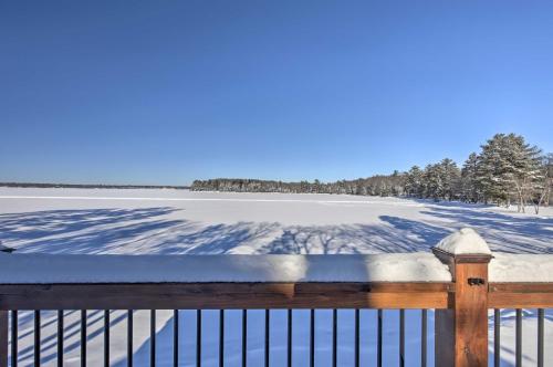 a fence in the snow with a snow covered field at Lakefront Cabin with Proximity to Attractions! in Minocqua