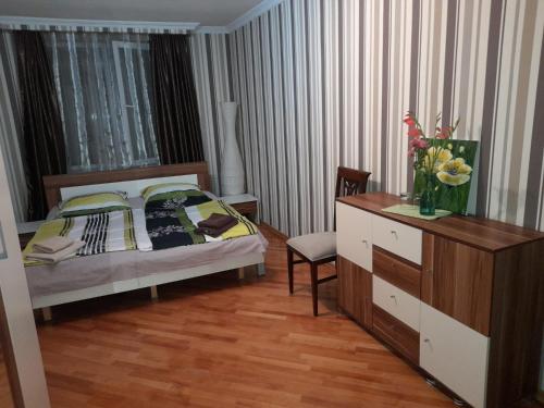 a bedroom with a bed and a dresser at Limi Sachkhere in Ssatschcheri