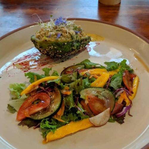 a plate of food with a salad on a table at Hostal Yakumama in Cuenca