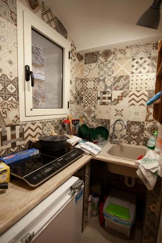 a kitchen with a sink and a counter top at la casetta in Sassari