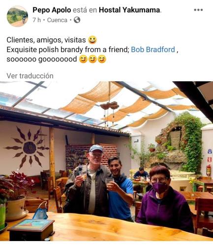 a group of three people sitting at a table at Hostal Yakumama in Cuenca