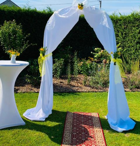 an arch for a wedding in the grass at Hotel Penzion Trámky in Vikýřovice