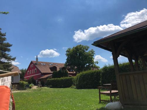 a yard with a gazebo and a house at Hotel Penzion Trámky in Vikýřovice