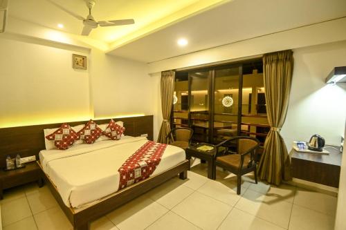 a bedroom with a bed and a dining room at The Divine Resort Somnath in Somnath