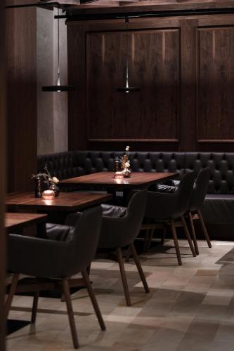 a dining room with two tables and chairs at Hotel Alte Post Südsteiermark in Leibnitz
