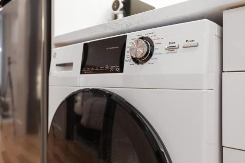 a white washer and dryer in a kitchen at The Iris in Charleston