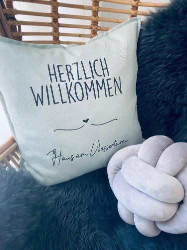 a pillow with the wordsforth williamumn on it at Haus am Wasserturm Gästezimmer in Schorndorf-Schlichten in Schorndorf