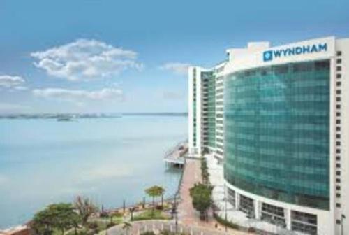 a rendering of a building with the ocean in the background at Ecusuites Puerto Santa Ana - River Junto a Hotel Wyndham in Guayaquil