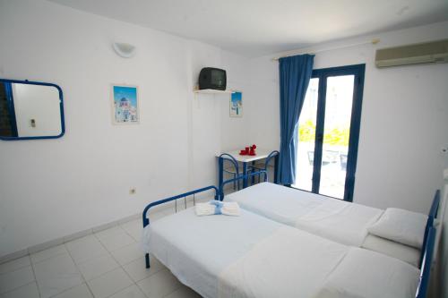 a hospital room with two beds and a window at Gorgona Studios in Livadi