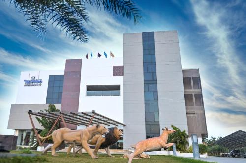 a statue of animals running in front of a building at The Divine Resort Somnath in Somnath