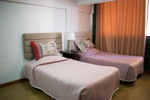 a bedroom with two beds and a window at Skyline in La Paz