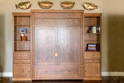 a large wooden hutch in a room at Elegant Lakefront Gem with Dock and Sunset Views! in Cross Hill