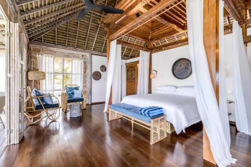 a bedroom with a bed and a wooden ceiling at Nayara Bocas del Toro in Bocas Town