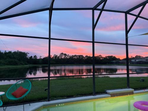 a view of a lake seen through a window at Aquamarine Hideaway in Kissimmee