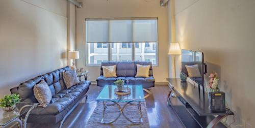 a living room with a couch and a tv at Midtown Fully Furnished Apartments - Great Location apts in Atlanta