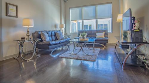 a living room with a couch and a table at Midtown Fully Furnished Apartments - Great Location apts in Atlanta