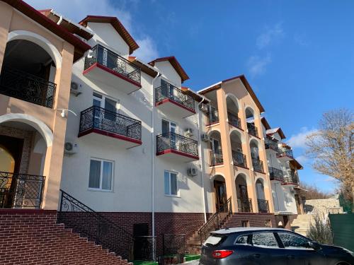 a building with a car parked in front of it at Park Hotel in Uman