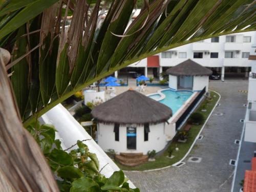 a view of a resort with a swimming pool at Arraial churrasco e mar 49 e 53 in Arraial do Cabo
