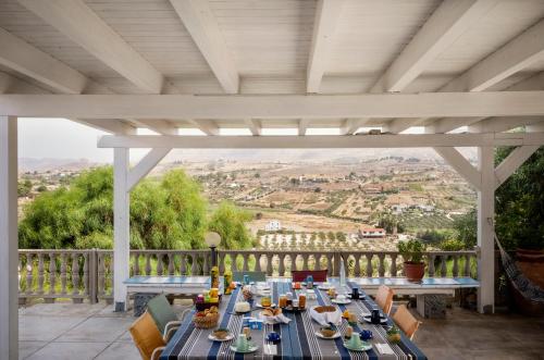 a table on a porch with a view of a city at B&B Monterosso in Realmonte