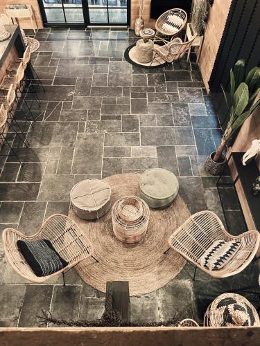 a circular table and chairs on a stone floor at Domaine Sur Les Sarts in Ohey